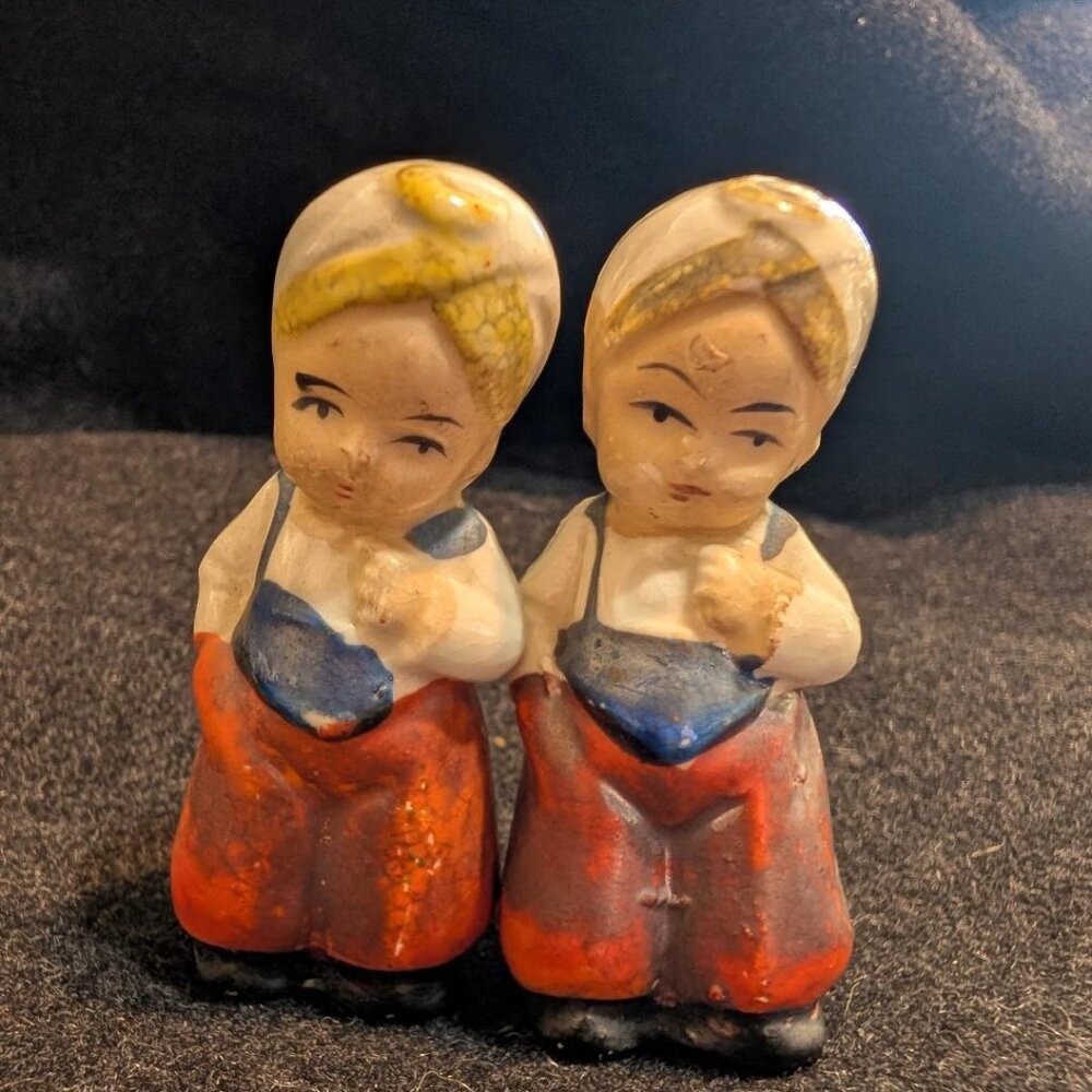 Ceramic salt and pepper shakers depicting Asian children in traditional attire